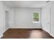 A bright bedroom with wooden floors, white walls, and closet at 1909 Meadow Ln, Decatur, GA 30032