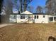 Charming white brick home with a well-maintained lawn and inviting front porch at 1909 Meadow Ln, Decatur, GA 30032