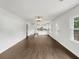Bright Living Room with dark floors, white walls, and kitchen in the background at 1909 Meadow Ln, Decatur, GA 30032