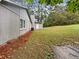 Side view of a house with green grass and tall trees at 4762 Huntsman Bnd, Decatur, GA 30034