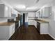 Bright kitchen featuring white cabinets, stainless steel appliances, and dark wood-look flooring at 4762 Huntsman Bnd, Decatur, GA 30034