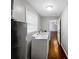 Functional laundry room featuring a washing machine and dryer with wood-look flooring at 4762 Huntsman Bnd, Decatur, GA 30034