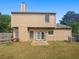 Home's backyard featuring a well-maintained lawn, mature trees, and privacy fence at 6235 Marbut Farms Trl, Lithonia, GA 30058