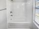 Bathroom featuring shower over tub and a window for natural light at 6235 Marbut Farms Trl, Lithonia, GA 30058