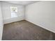 A bright bedroom with neutral walls, carpeted floors and natural light at 6235 Marbut Farms Trl, Lithonia, GA 30058