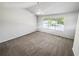 Spacious bedroom with vaulted ceiling, neutral walls, carpeted floors, and natural light from the window at 6235 Marbut Farms Trl, Lithonia, GA 30058