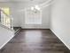 Bright dining room featuring hardwood floors, neutral walls and a contemporary chandelier at 6235 Marbut Farms Trl, Lithonia, GA 30058