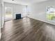 Sunlit living room boasts hardwood floors and fireplace at 6235 Marbut Farms Trl, Lithonia, GA 30058