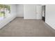 Spacious bedroom with plush carpet, large windows, and plenty of natural light at 6235 Marbut Farms Trl, Lithonia, GA 30058