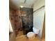 This bathroom features a glass shower with stone tile and modern fixtures at 195 14Th Ne St # 2103, Atlanta, GA 30309