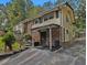 A multi-level home with a side entry and covered parking, accented by brick and light siding at 2497 Mobley Se Ct, Atlanta, GA 30315