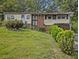 Charming single-story home featuring a brick accent, complemented by mature landscaping for added curb appeal at 2497 Mobley Se Ct, Atlanta, GA 30315