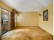 Open room featuring unique metal security door, complementing the carpeted floor and yellow walls at 2497 Mobley Se Ct, Atlanta, GA 30315