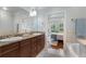 Elegant bathroom with double vanity, granite countertop, and a soaking tub at 37 Honour Nw Ave, Atlanta, GA 30305