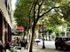 View of the street with trees, street lights, and shops at 878 Peachtree Ne St # 634, Atlanta, GA 30309