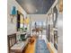 Welcoming hallway with star patterned ceiling, herringbone floors and views of city through living room windows at 2575 Peachtree Ne Rd # 14A, Atlanta, GA 30305