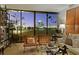 Bright living room with modern furniture, shelving and floor to ceiling windows offering a view of the city at 2575 Peachtree Ne Rd # 14A, Atlanta, GA 30305