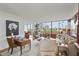 Bright living room with full window view of city. Wood desk and bookshelf at 2575 Peachtree Ne Rd # 14A, Atlanta, GA 30305