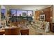 Elegant living room featuring floor-to-ceiling windows with city views, wood paneling, and stylish contemporary furnishings at 2575 Peachtree Ne Rd # 14A, Atlanta, GA 30305