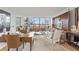 Inviting living room featuring a writing desk, modern furnishings, wood paneling, and expansive city views at 2575 Peachtree Ne Rd # 14A, Atlanta, GA 30305