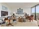 Bright living room featuring neutral tones, unique art and decor, and a wall of windows at 2575 Peachtree Ne Rd # 14A, Atlanta, GA 30305