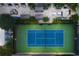 Aerial view of a tennis court, outdoor lounge area, outdoor cabanas, and lush landscaping at 3445 Stratford Ne Rd # 3601, Atlanta, GA 30326