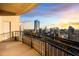 Expansive balcony with black metal railing overlooking the city skyline at sunset at 3445 Stratford Ne Rd # 3601, Atlanta, GA 30326
