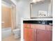 A clean bathroom with a shower-tub combo, black countertop, and a mirrored cabinet providing a modern and functional space at 3445 Stratford Ne Rd # 3601, Atlanta, GA 30326