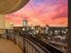 Breathtaking city view from a condo balcony showcasing a colorful sunset over modern buildings at 3445 Stratford Ne Rd # 3601, Atlanta, GA 30326