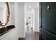 Elegant foyer with dark wood floors, white walls, and decorative mirror; a welcoming entrance to a stylish home at 3445 Stratford Ne Rd # 3601, Atlanta, GA 30326