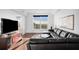 Comfortable living room with dark wood floors, black leather couch and expansive windows at 3445 Stratford Ne Rd # 3601, Atlanta, GA 30326