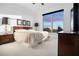 Serene bedroom with city views, featuring carpet, a king-sized bed, bedside lamps, and tasteful decor at 3445 Stratford Ne Rd # 3601, Atlanta, GA 30326