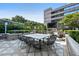 Outdoor dining area with large table, seating, an outdoor TV, grilling area, and lush landscaping at 3445 Stratford Ne Rd # 3601, Atlanta, GA 30326