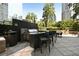 Outdoor grilling area featuring a stainless steel grill, bar seating, and well maintained landscaping at 3445 Stratford Ne Rd # 3601, Atlanta, GA 30326
