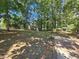 Large, grassy backyard featuring mature trees and the tranquil sounds of nature at 215 Moseley Crossing Dr, Stockbridge, GA 30281