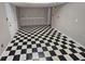 Finished basement area with classic black and white checkered flooring and neutral wall color at 215 Moseley Crossing Dr, Stockbridge, GA 30281