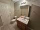 Cozy bathroom featuring a single vanity and tiled floor, creating a functional and practical space at 215 Moseley Crossing Dr, Stockbridge, GA 30281