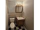 Cozy bathroom with a single vanity, mirror, and checkered flooring, offering a functional and vintage space at 215 Moseley Crossing Dr, Stockbridge, GA 30281