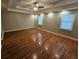 Spacious bedroom featuring hardwood floors, tray ceiling, recessed lighting, and two windows at 215 Moseley Crossing Dr, Stockbridge, GA 30281