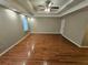 Bedroom featuring hardwood floors, recessed lighting, tray ceiling, and a window at 215 Moseley Crossing Dr, Stockbridge, GA 30281