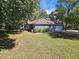 Charming single-story home with well-manicured lawn, blue siding and an attached two car garage at 215 Moseley Crossing Dr, Stockbridge, GA 30281