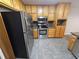 Stainless steel oven and refrigerator with wooden cabinets in kitchen at 215 Moseley Crossing Dr, Stockbridge, GA 30281