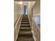 Carpeted stairway to the upper level, providing seamless transition between floors in this inviting home at 215 Moseley Crossing Dr, Stockbridge, GA 30281