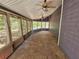 Relaxing sunroom featuring multiple windows, dual ceiling fans, and a peaceful view of the surrounding trees at 215 Moseley Crossing Dr, Stockbridge, GA 30281