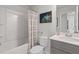 Clean bathroom featuring a shower, a gray vanity with double sinks, and a decorative mirror at 3136 Washburn Se St, Atlanta, GA 30354