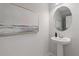 Elegant powder room with pedestal sink, decorative mirror, and modern accents at 3136 Washburn Se St, Atlanta, GA 30354