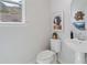 Charming powder room with pedestal sink, stylish mirror, and serene decor at 3136 Washburn Se St, Atlanta, GA 30354