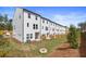 Row of new townhomes features pristine lawns, fenced yards, and modern design at 3136 Washburn Se St, Atlanta, GA 30354