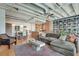 Open-concept living room features hardwood floors, exposed ceilings, and a large bookshelf, creating a cozy atmosphere at 805 Peachtree Ne St # 401, Atlanta, GA 30308