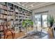 Charming living room featuring a bookshelf, wood floors, a decorative rug, and access to the balcony at 805 Peachtree Ne St # 401, Atlanta, GA 30308